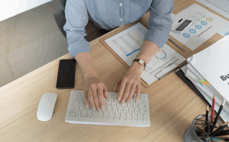 Person typing on computer keyboard