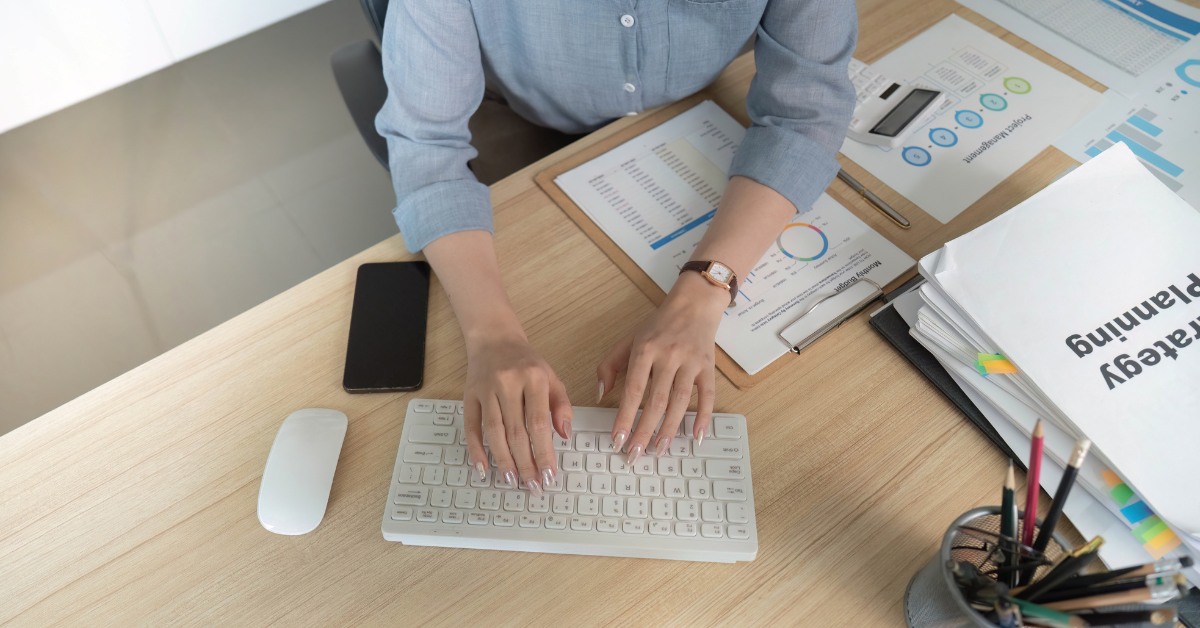 Person typing on computer keyboard