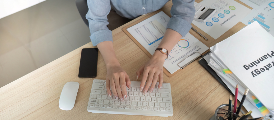 Person typing on computer keyboard